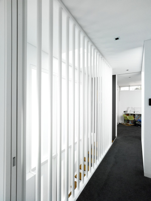 Стильный дизайн: коридор среднего размера в современном стиле с белыми стенами, ковровым покрытием и черным полом - последний тренд