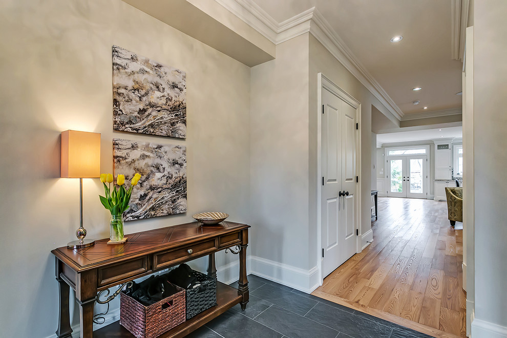 Example of a mid-sized transitional slate floor hallway design in Toronto with beige walls