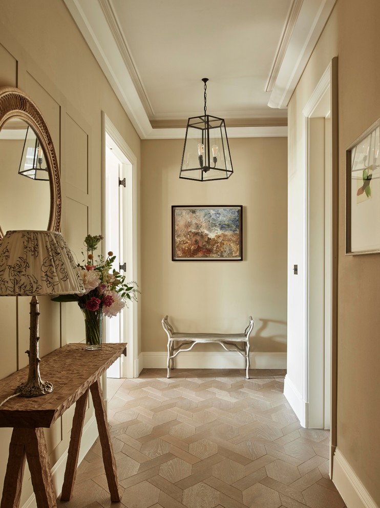 Mid-sized trendy medium tone wood floor and brown floor hallway photo in Essex with beige walls