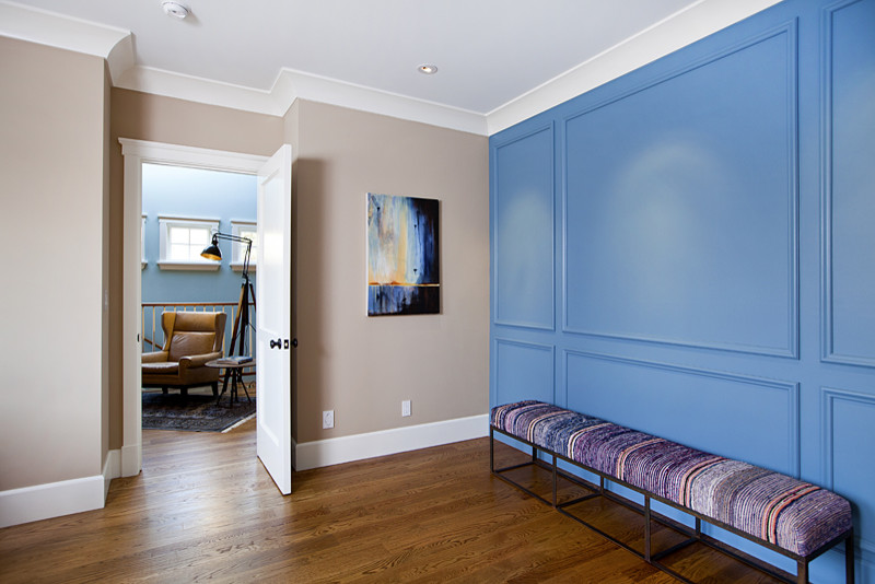 Hallway - large contemporary medium tone wood floor and brown floor hallway idea in Los Angeles with beige walls