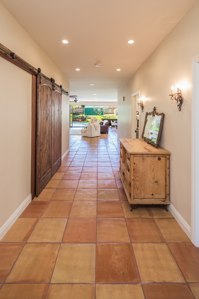 Example of a mid-sized tuscan ceramic tile hallway design in San Diego with beige walls