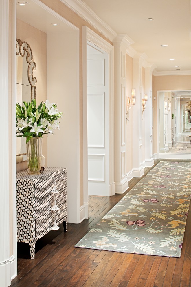 Hallway - traditional dark wood floor and brown floor hallway idea in Miami with beige walls