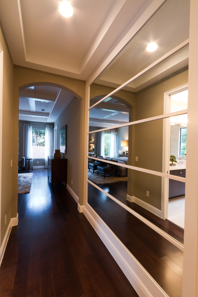 Example of a mid-sized tuscan porcelain tile hallway design in Orlando with brown walls