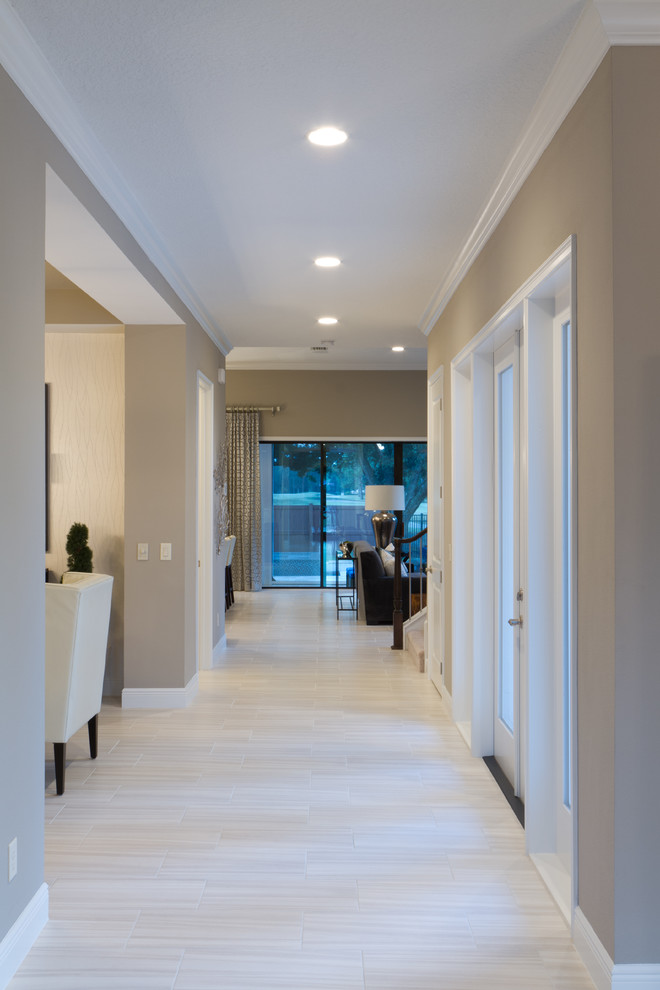 Example of a mid-sized tuscan porcelain tile hallway design in Orlando with brown walls
