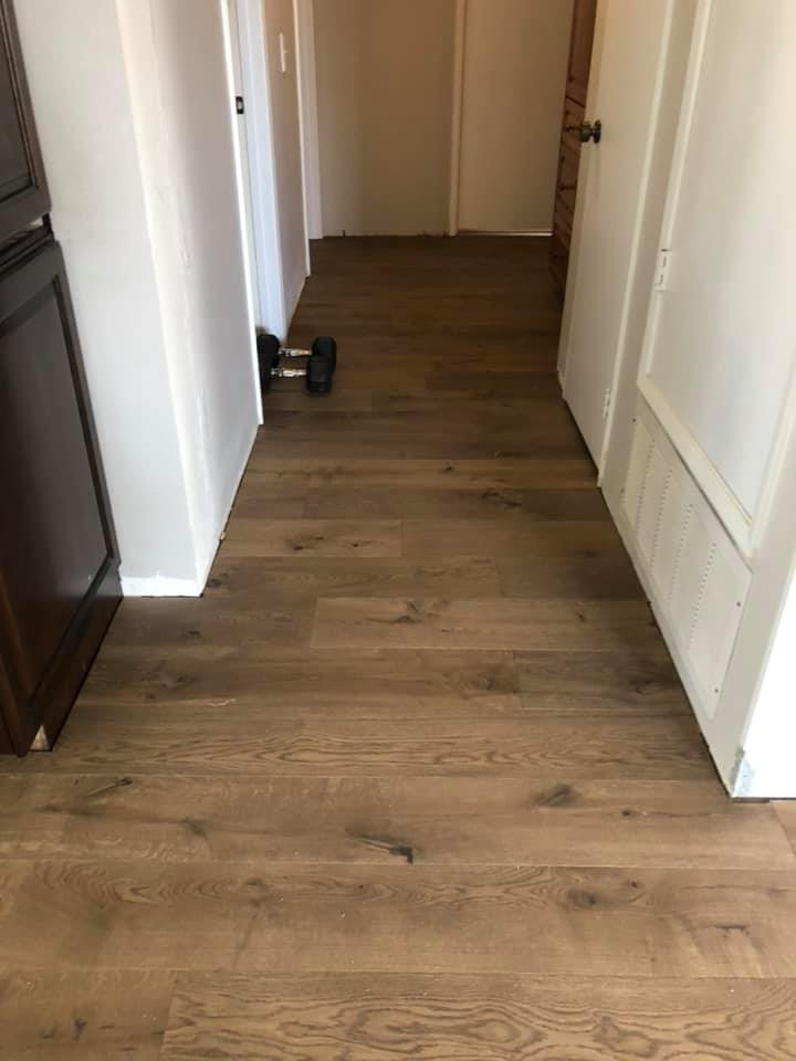 Inspiration for a mid-sized timeless medium tone wood floor and brown floor hallway remodel in San Diego with beige walls