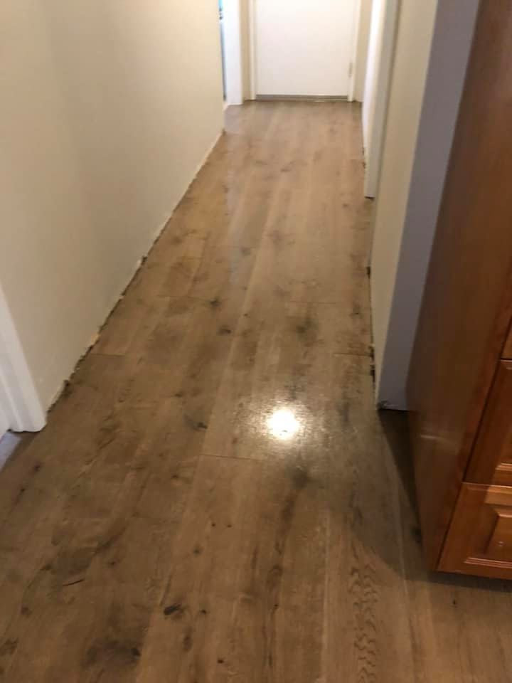Example of a mid-sized classic medium tone wood floor and brown floor hallway design in San Diego with beige walls