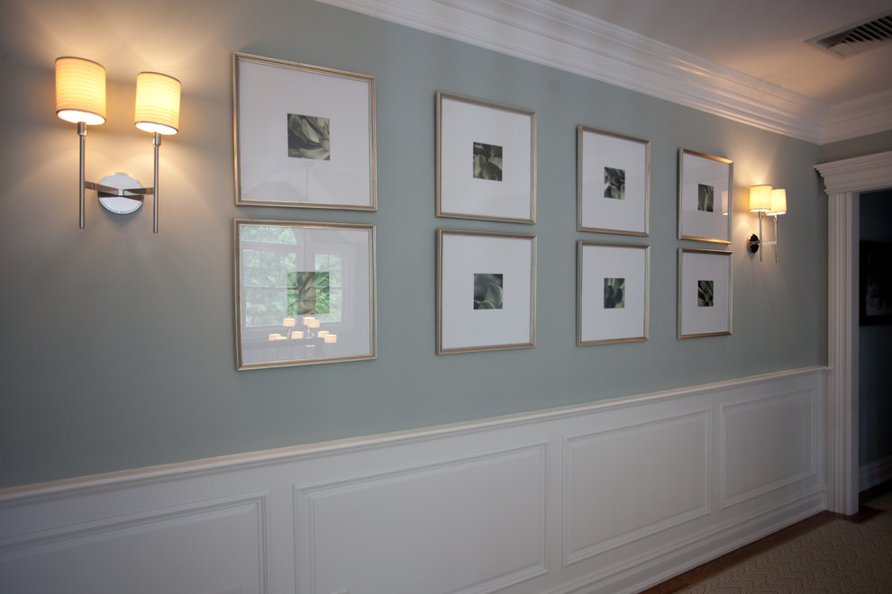 Example of a mid-sized transitional medium tone wood floor hallway design in New York with blue walls