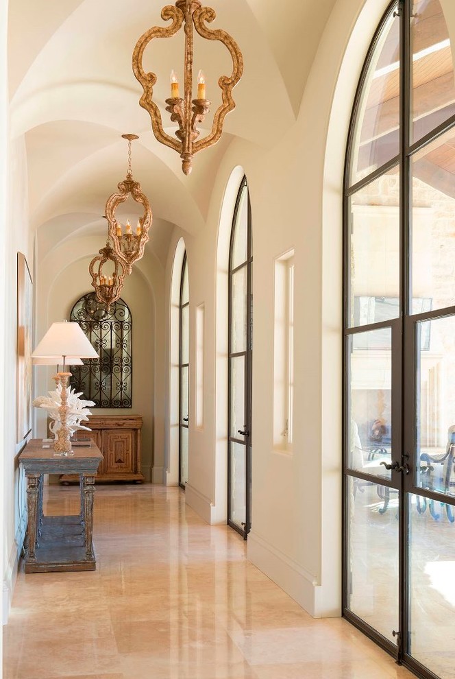Mid-sized tuscan travertine floor hallway photo in Dallas with white walls