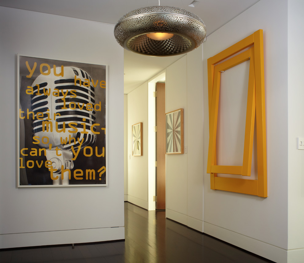 Inspiration for a contemporary dark wood floor hallway remodel in New York with white walls