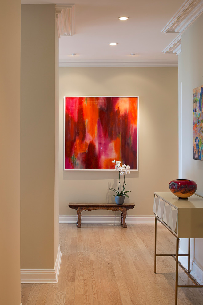 Hallway - mid-sized transitional light wood floor and beige floor hallway idea in Boston with beige walls