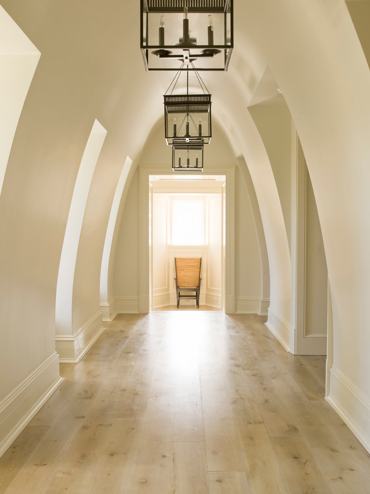 На фото: коридор в классическом стиле с белыми стенами и светлым паркетным полом