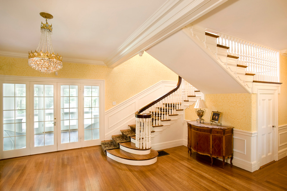 Inspiration for a timeless light wood floor hallway remodel in Boston with yellow walls