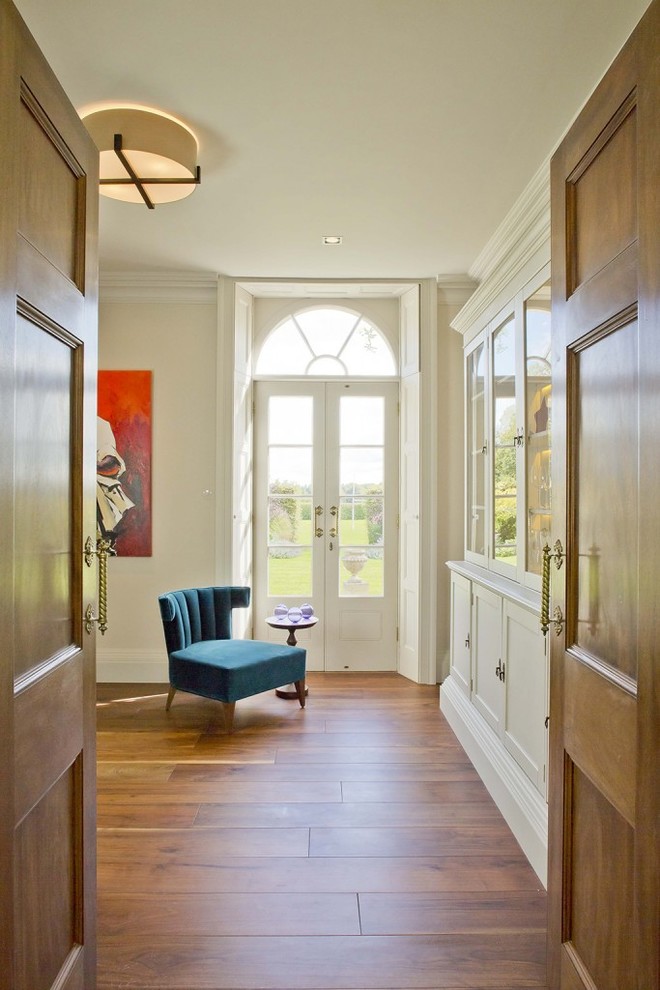 Idee per un ingresso o corridoio tradizionale con pareti bianche e pavimento in legno massello medio