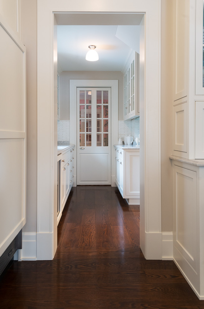 Example of a classic medium tone wood floor hallway design in Chicago with blue walls