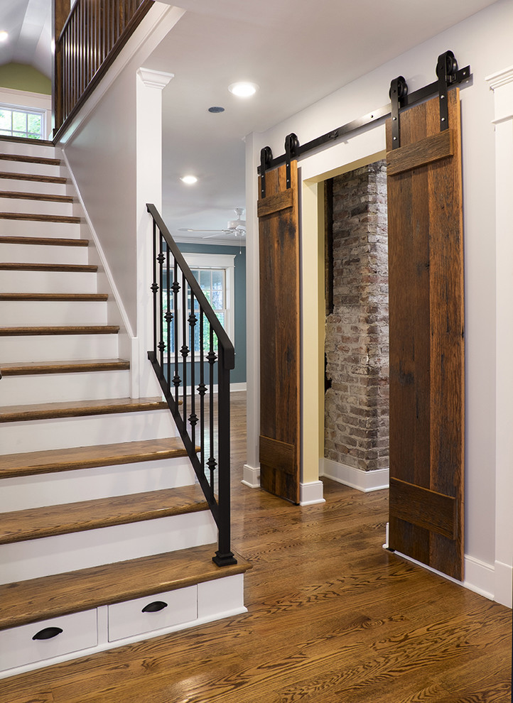 Example of a mid-sized classic medium tone wood floor hallway design in Louisville with gray walls