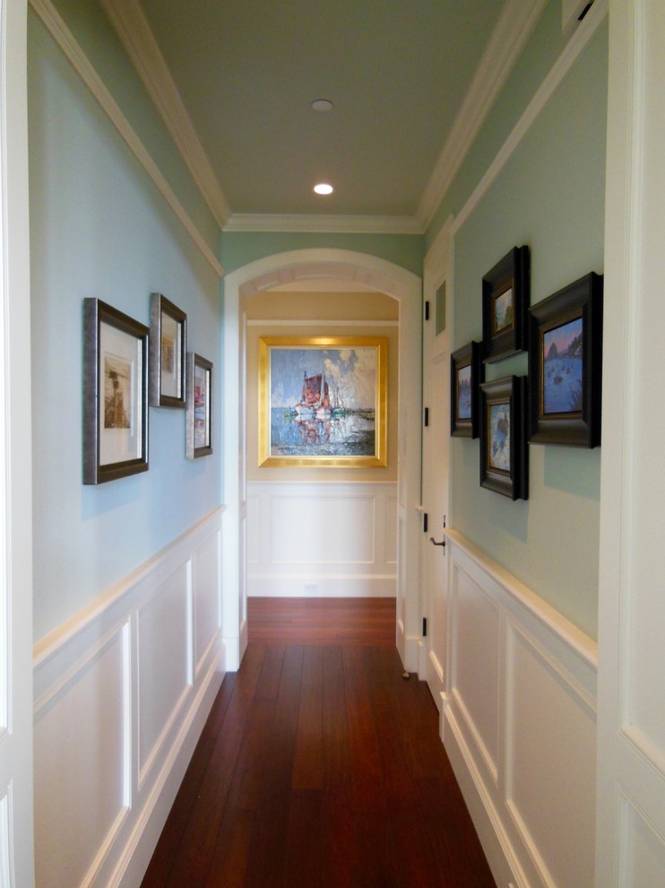 Mid-sized transitional medium tone wood floor and brown floor hallway photo in San Diego with gray walls