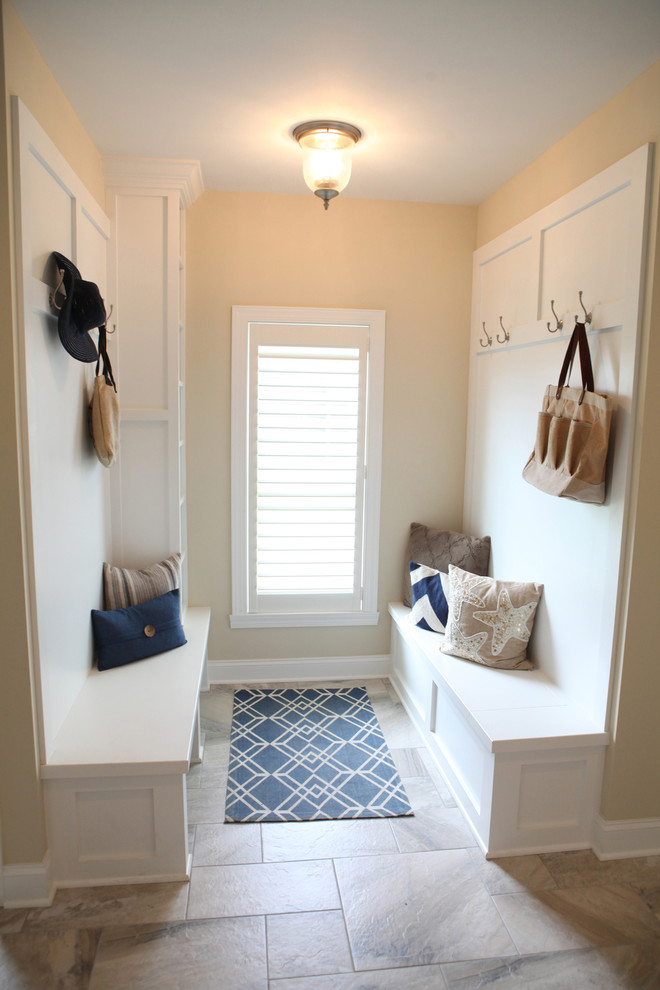 Example of a mid-sized beach style porcelain tile and beige floor hallway design in New York with beige walls