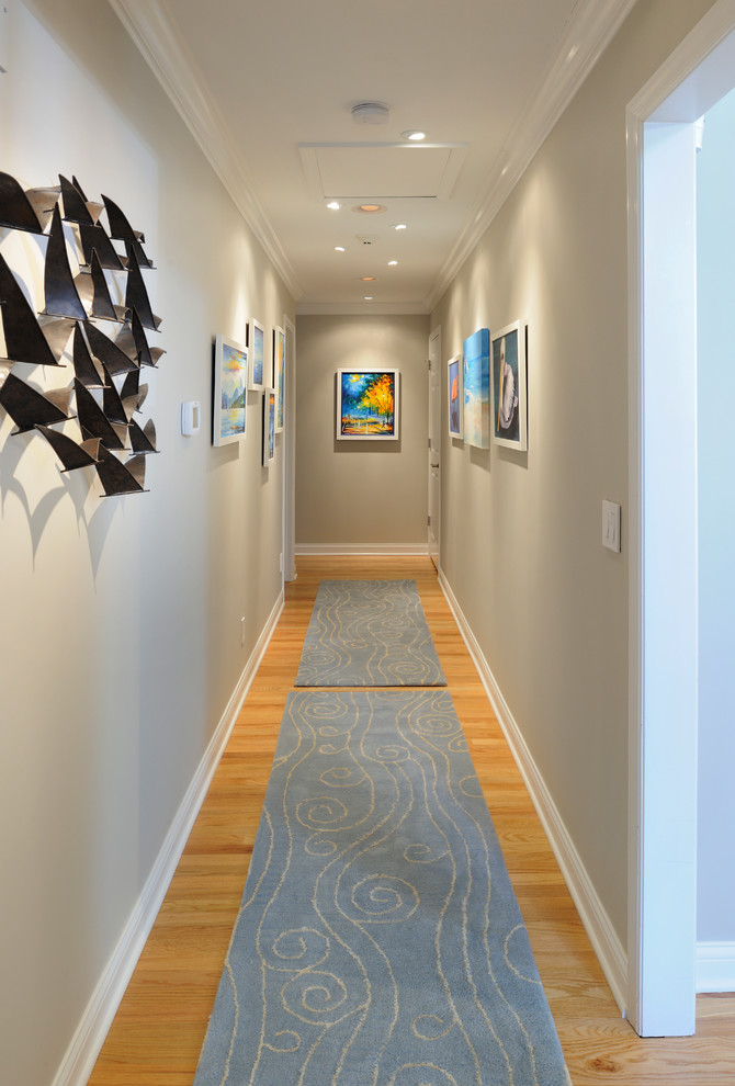Hallway - mid-sized coastal light wood floor hallway idea in St Louis with gray walls