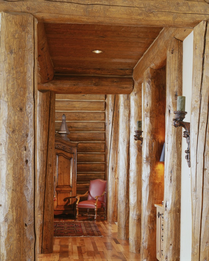 Example of a mid-sized mountain style light wood floor hallway design in Denver with beige walls