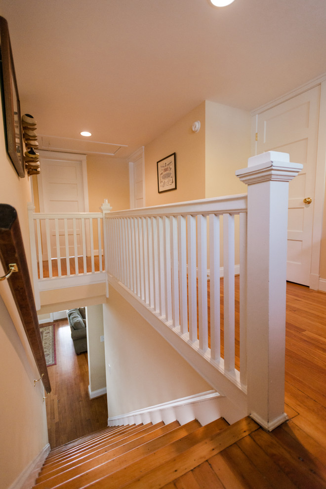 Inspiration for a mid-sized timeless medium tone wood floor and brown floor hallway remodel in Baltimore with beige walls