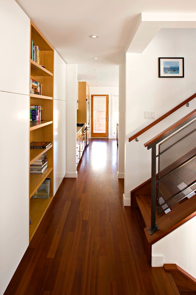 Esempio di un piccolo ingresso o corridoio minimalista con pareti bianche e pavimento in legno massello medio