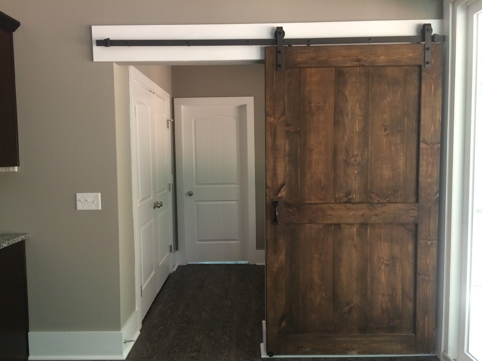 Example of a mid-sized arts and crafts dark wood floor hallway design in Other with gray walls