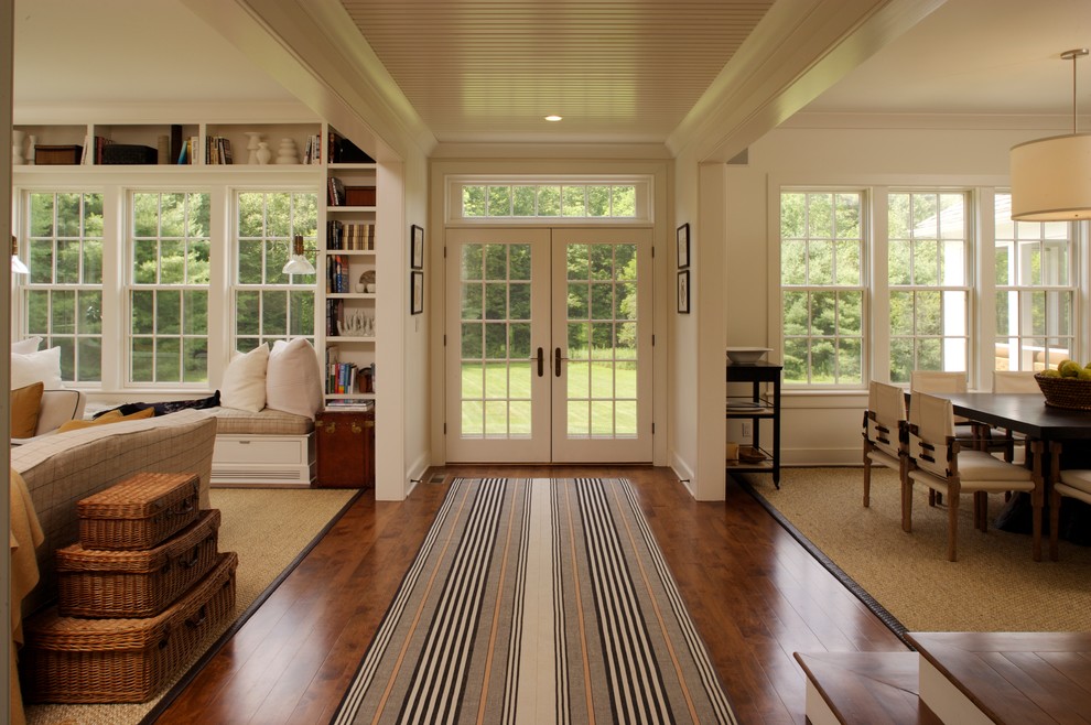Inspiration for a large cottage medium tone wood floor hallway remodel in Boston with white walls