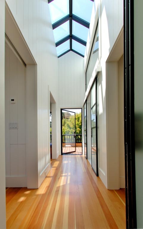 Hallway - large contemporary medium tone wood floor hallway idea in San Francisco