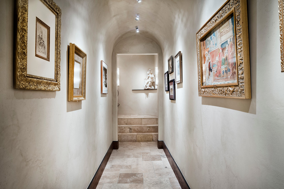 Tuscan beige floor hallway photo in Austin with gray walls