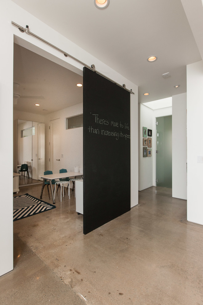 Hallway - contemporary concrete floor and gray floor hallway idea in Orange County with white walls