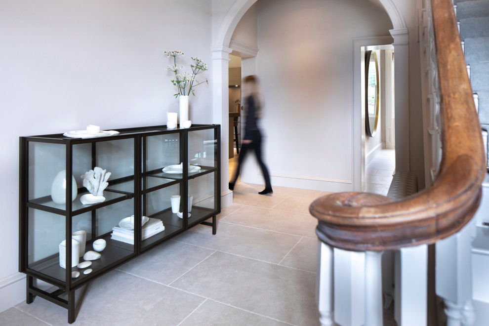 Example of a large trendy ceramic tile and white floor hallway design in Oxfordshire with white walls