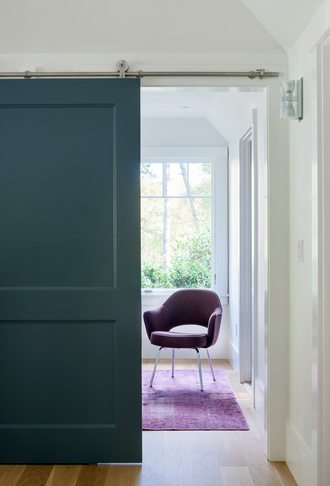 Hallway - contemporary medium tone wood floor hallway idea in Boston with white walls