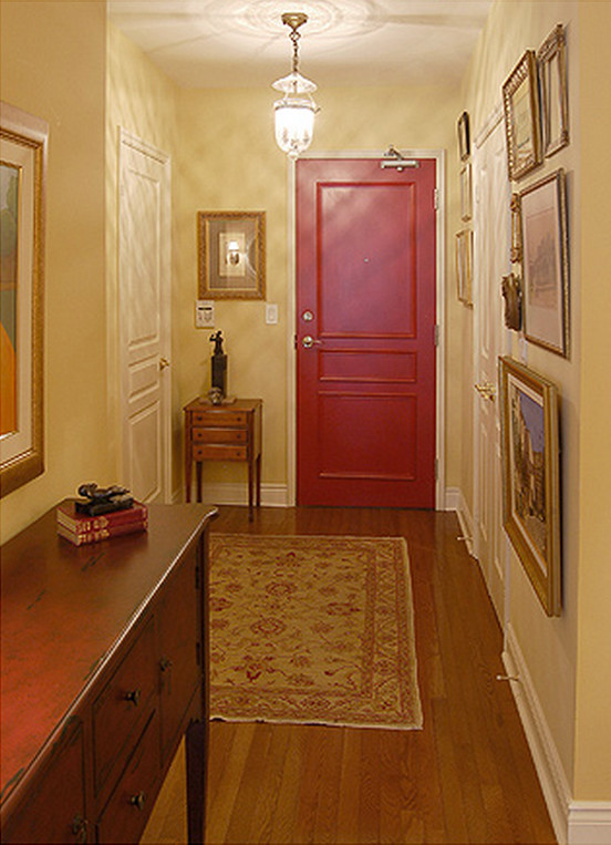 Example of a small classic medium tone wood floor hallway design in Toronto with yellow walls