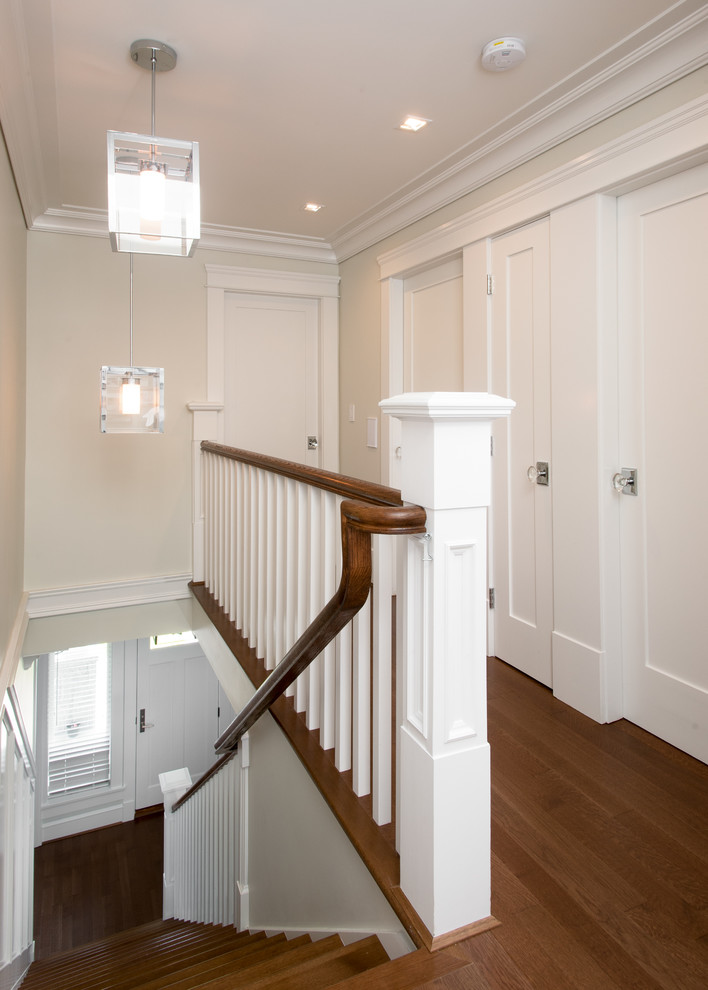 Large arts and crafts medium tone wood floor hallway photo in Vancouver with gray walls