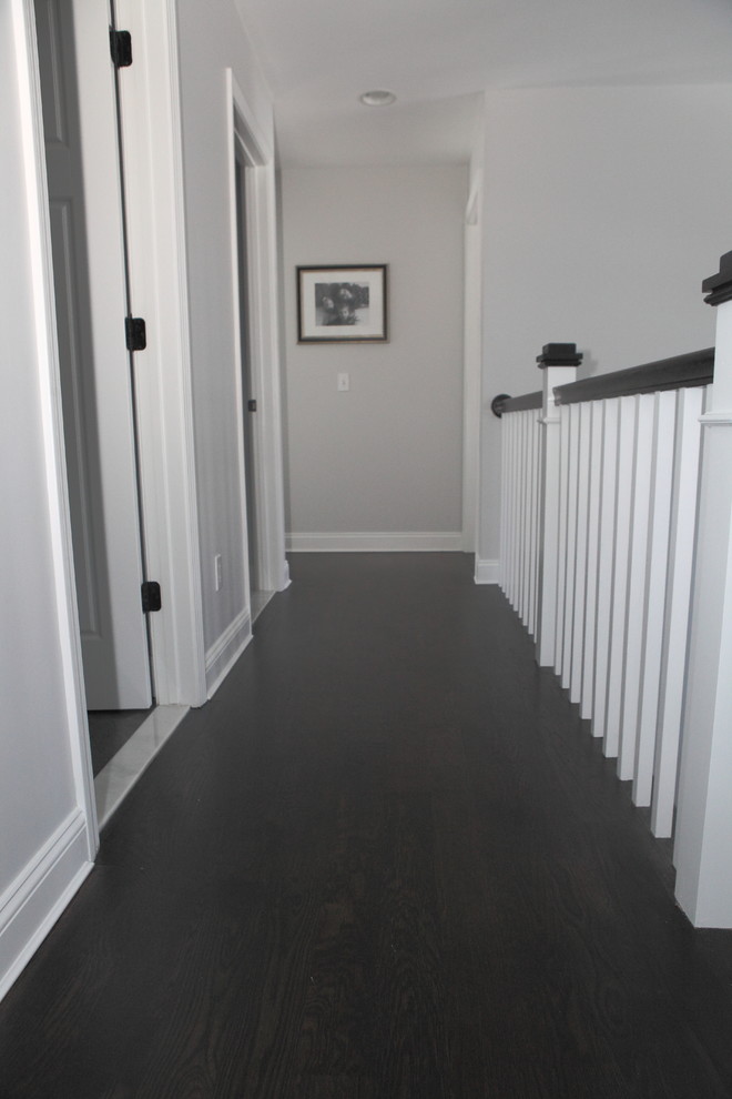 Example of a mid-sized arts and crafts dark wood floor hallway design in Providence with gray walls