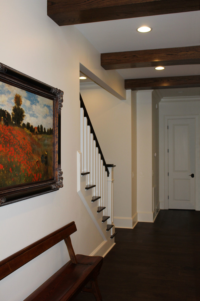 Large arts and crafts dark wood floor and brown floor hallway photo in Atlanta with white walls