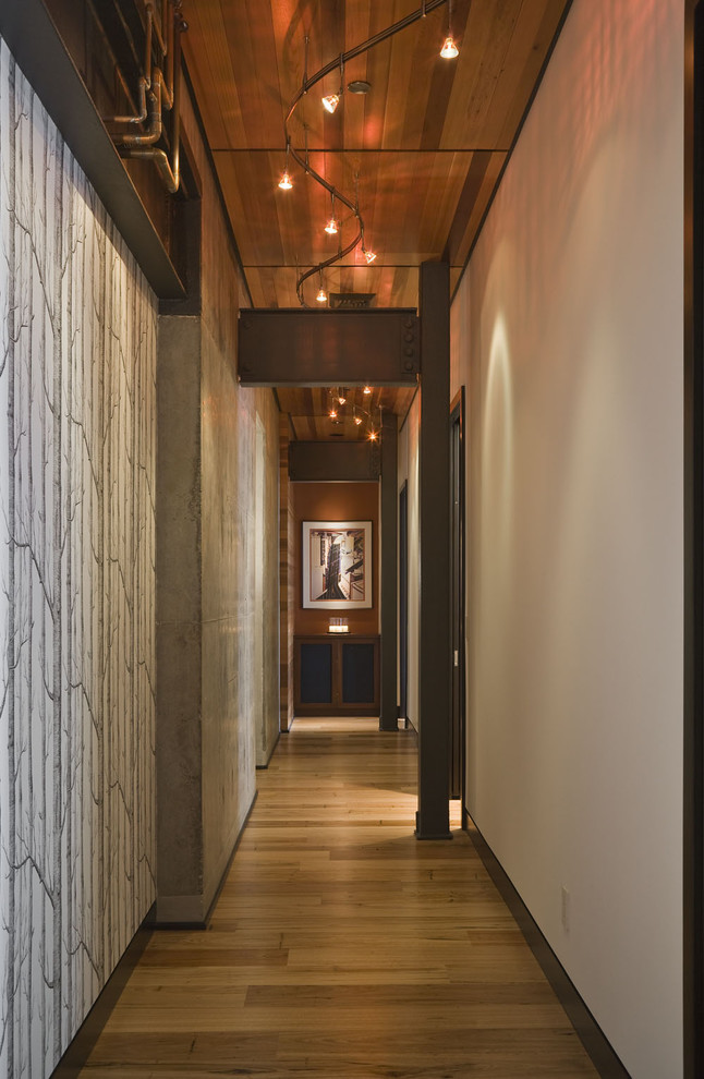 Hallway - contemporary medium tone wood floor hallway idea in Portland with white walls