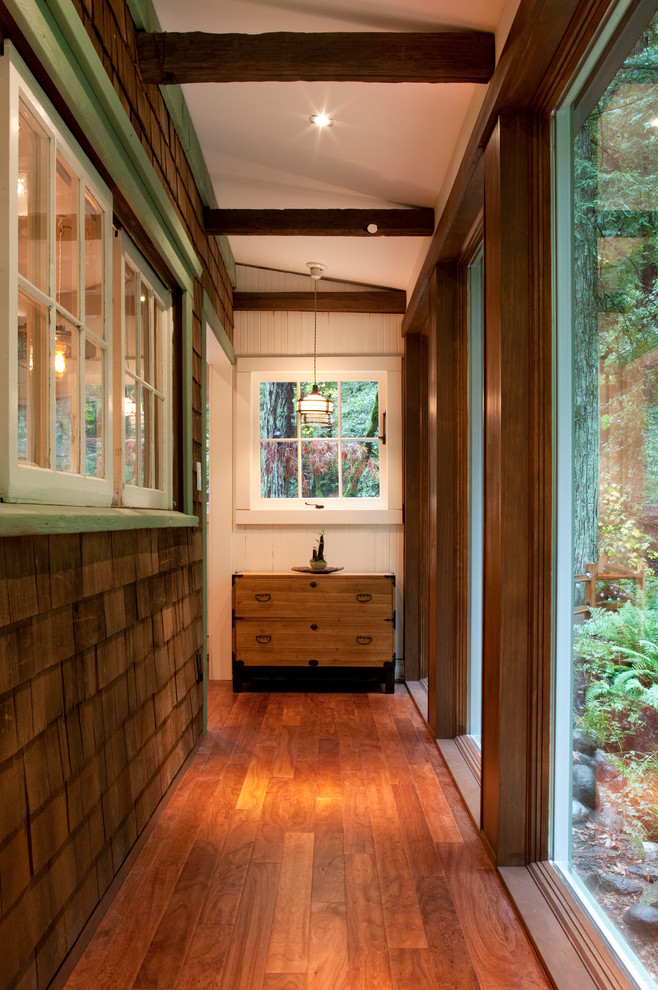 Hallway - mid-sized rustic medium tone wood floor hallway idea in San Francisco with brown walls