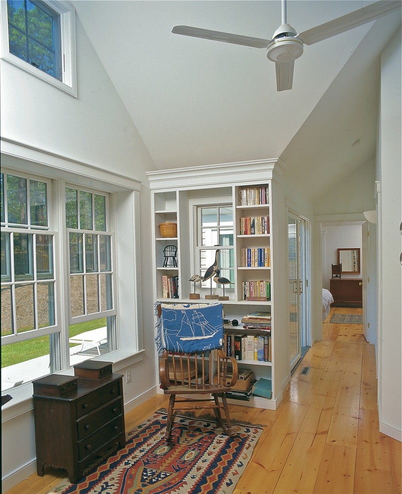 Mid-sized elegant medium tone wood floor and brown floor hallway photo in Boston with white walls