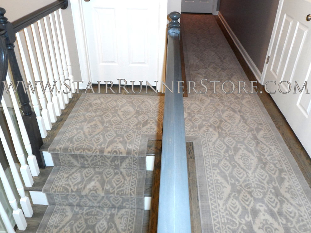 Inspiration for a large transitional gray floor and medium tone wood floor hallway remodel in New York with gray walls