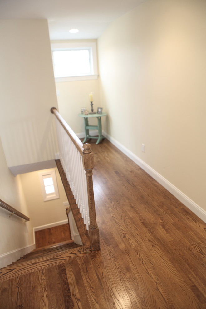 Example of a classic medium tone wood floor hallway design in Providence with beige walls