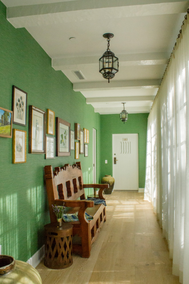 Inspiration pour un couloir méditerranéen de taille moyenne avec un mur vert et un sol en bois brun.