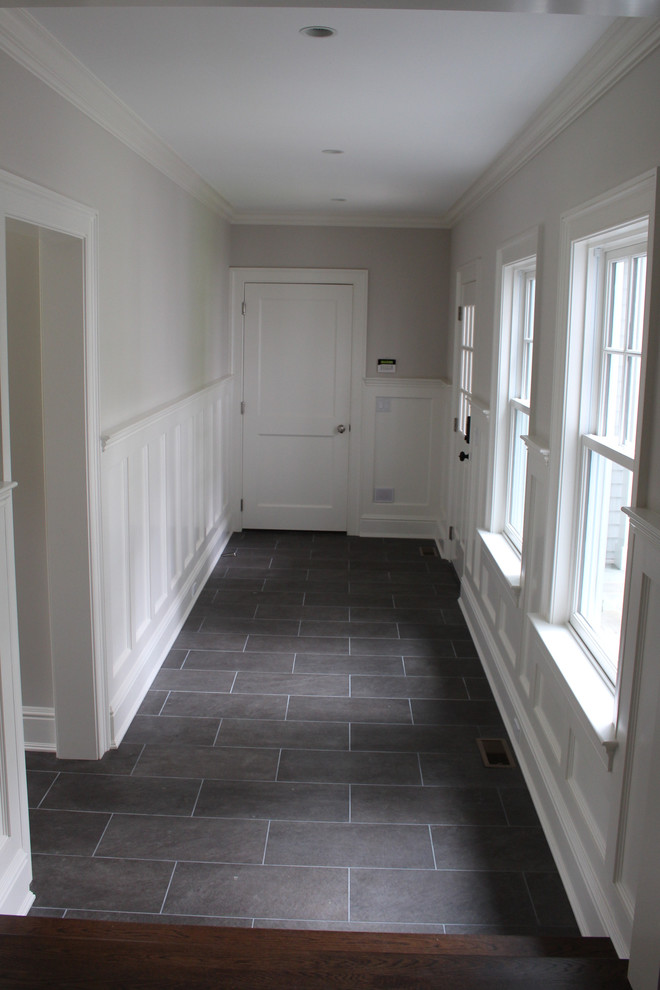 Hallway - mid-sized transitional porcelain tile hallway idea in New York with gray walls