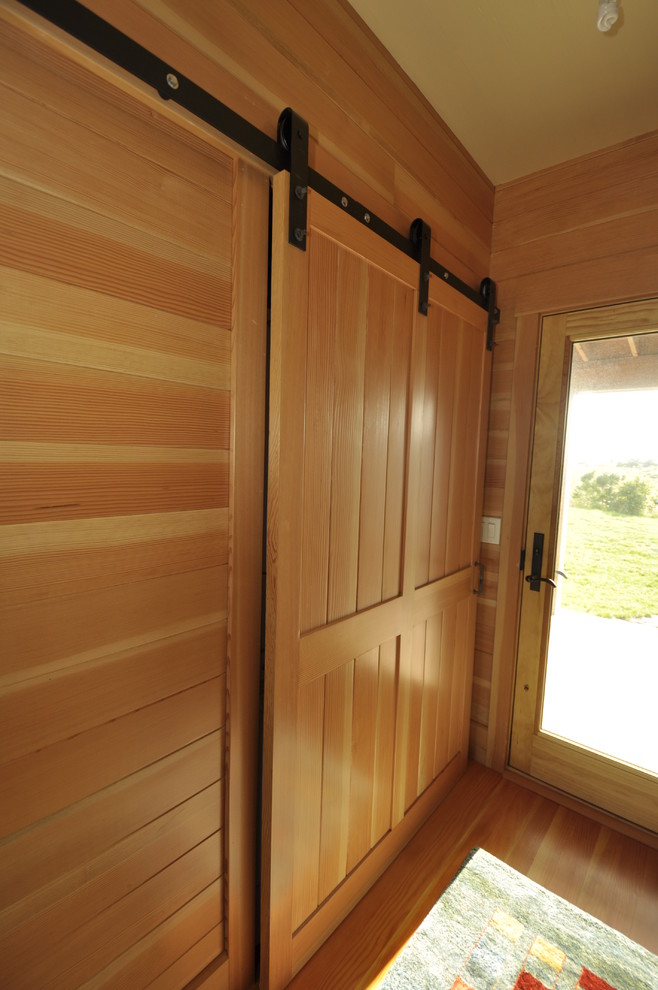 Idée de décoration pour un couloir vintage de taille moyenne avec un mur marron, un sol en bois brun et un sol marron.