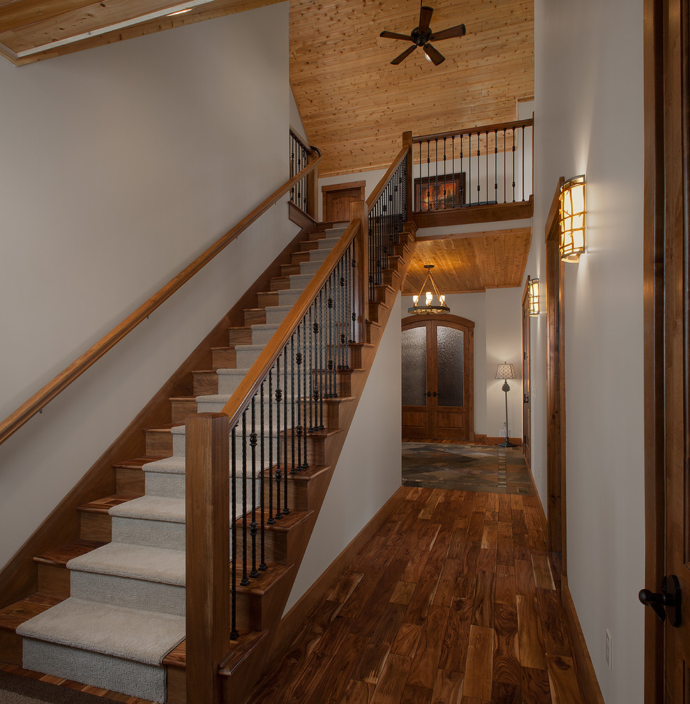 Mountain style light wood floor hallway photo in Grand Rapids with green walls