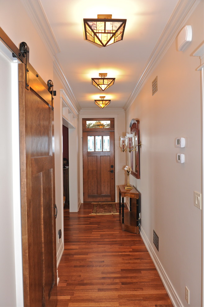 Foto di un ingresso o corridoio stile americano di medie dimensioni con pareti bianche e pavimento in legno massello medio