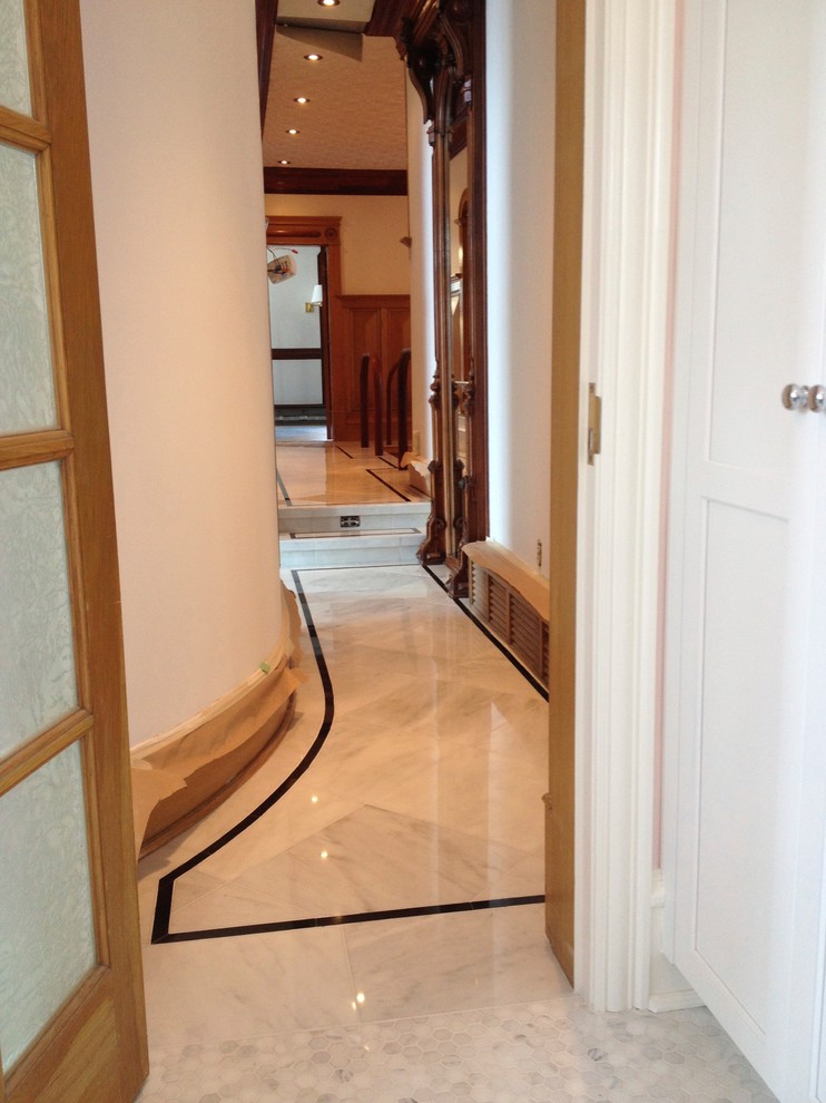 Hallway - traditional marble floor hallway idea in Edmonton with white walls