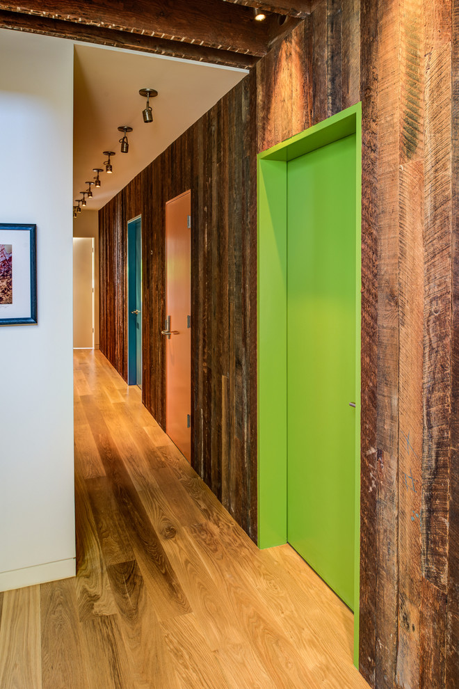 Ejemplo de recibidores y pasillos actuales con suelo de madera en tonos medios