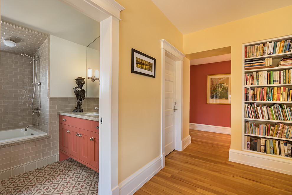 Inspiration pour un couloir traditionnel de taille moyenne avec un mur jaune, parquet foncé et un sol marron.