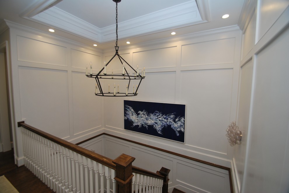 Example of a large transitional dark wood floor and brown floor hallway design in DC Metro with white walls